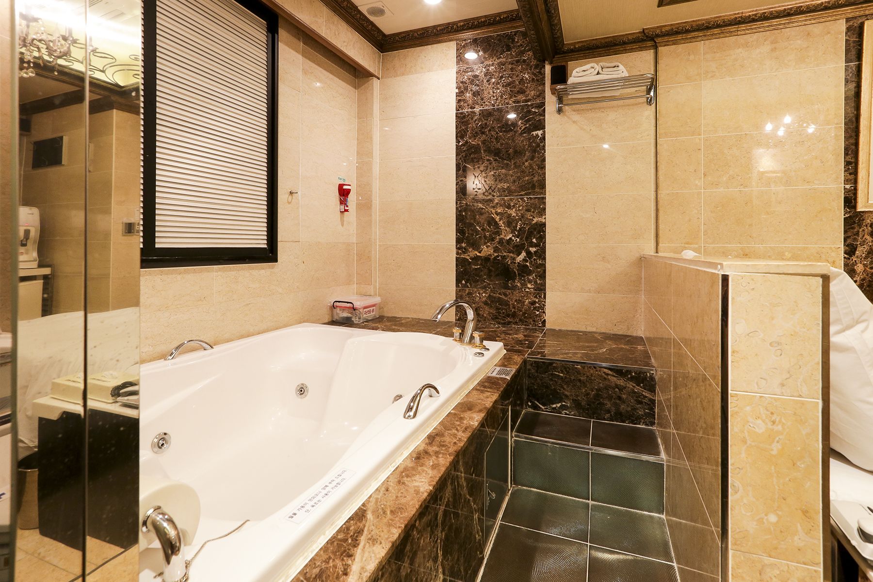 A modern bathroom with a large bathtub, a shower area, and a vanity with a mirror.