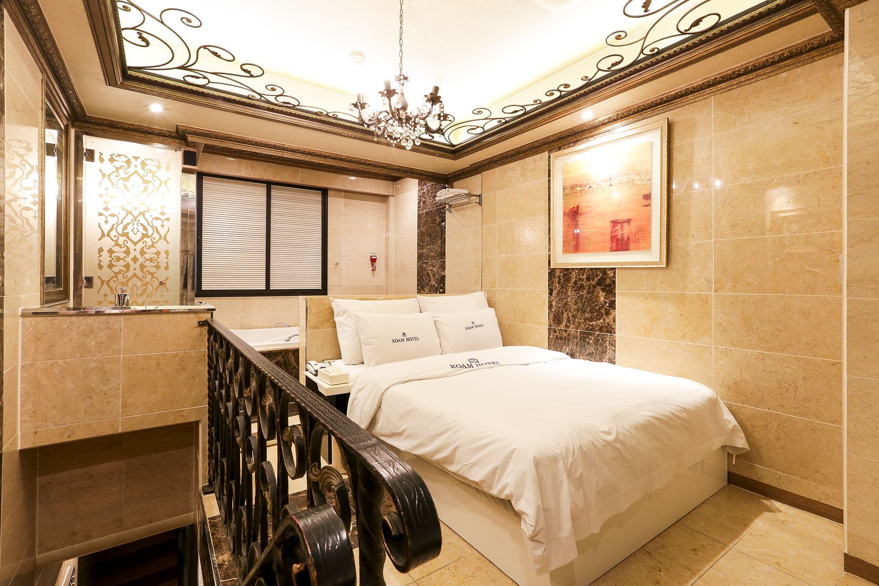 A hotel room with a bed, a bathroom, and a staircase.