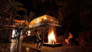Un área de estar al aire libre con una chimenea y una estructura cubierta.
