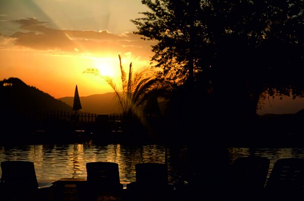 Seasonal outdoor pool, open 10:00 AM to 7 PM, pool umbrellas