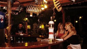 A bar area with a counter, a Pepsi sign, and a decorative light fixture. - Pink Palace Hotel (Fethiye)