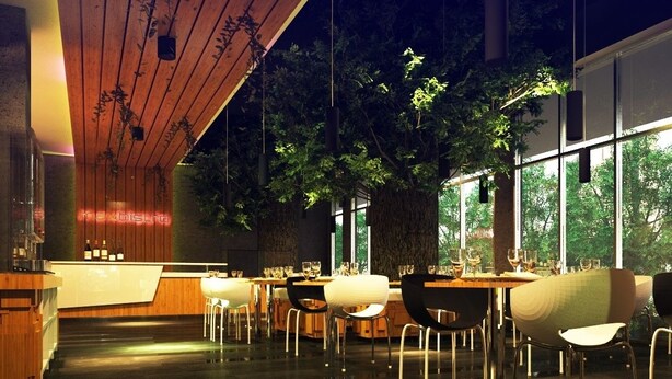 A modern restaurant interior with a wooden ceiling, large windows, and a central tree. Tables and chairs are arranged for dining. - Maxone Hotels at Malang (Malang)