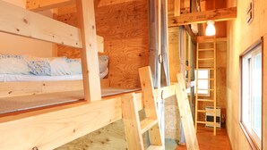 A wooden interior with bunk beds, a ladder, and a window. - SappoLodge - Hostel (Sapporo)
