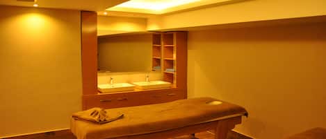 Una habitación con un banco de madera, dos lavamanos y un espejo sobre ellos.