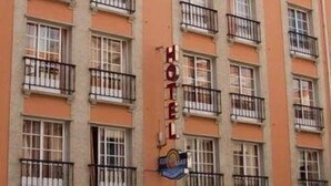A multi-story hotel with balconies, a visible sign reading "HOTEL," and a partial view of a sign below that says "HOTEL FLORIDA MA." - Florida Mar Hotel (Sanxenxo)
