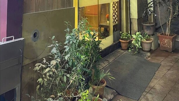 The exterior of Concord Galaxy hotel with a signboard in a local language, potted plants, and a wooden ceiling. - Hotel Concord Galaxy (Mumbai)