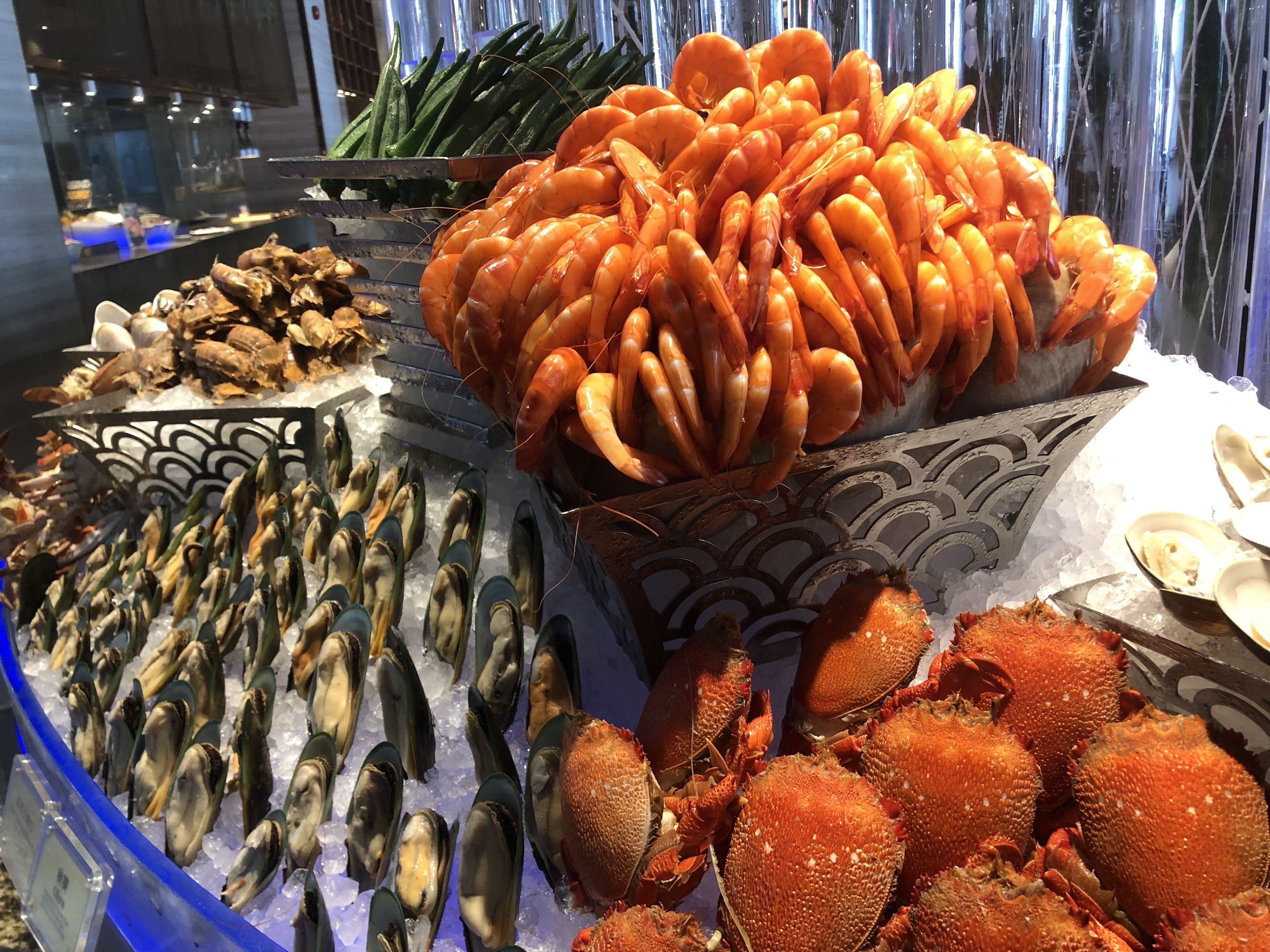 Un présentoir de fruits de mer avec différents types de crustacés et de crevettes.