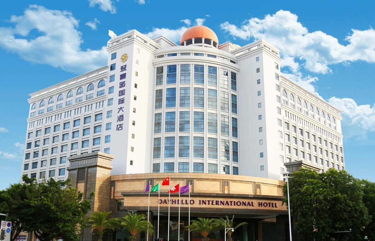 A large, multi-story building with a prominent dome on top, featuring a sign for the Day-Hello International Hotel.