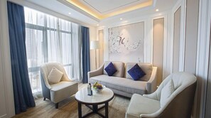Business Suite, 1 King Bed | Living area | 42-inch LCD TV with cable channels, TV, pay movies