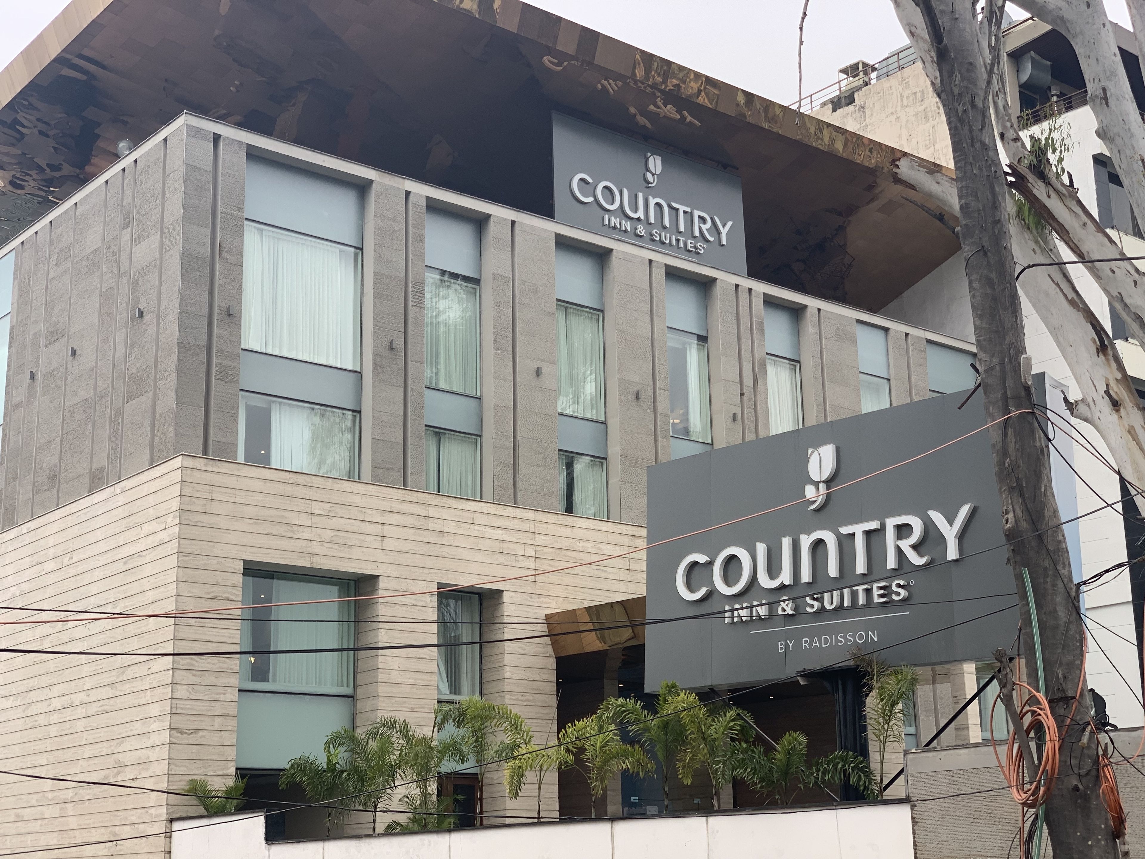 A modern building with a sign for 'Country Inn & Suites by Radisson'.