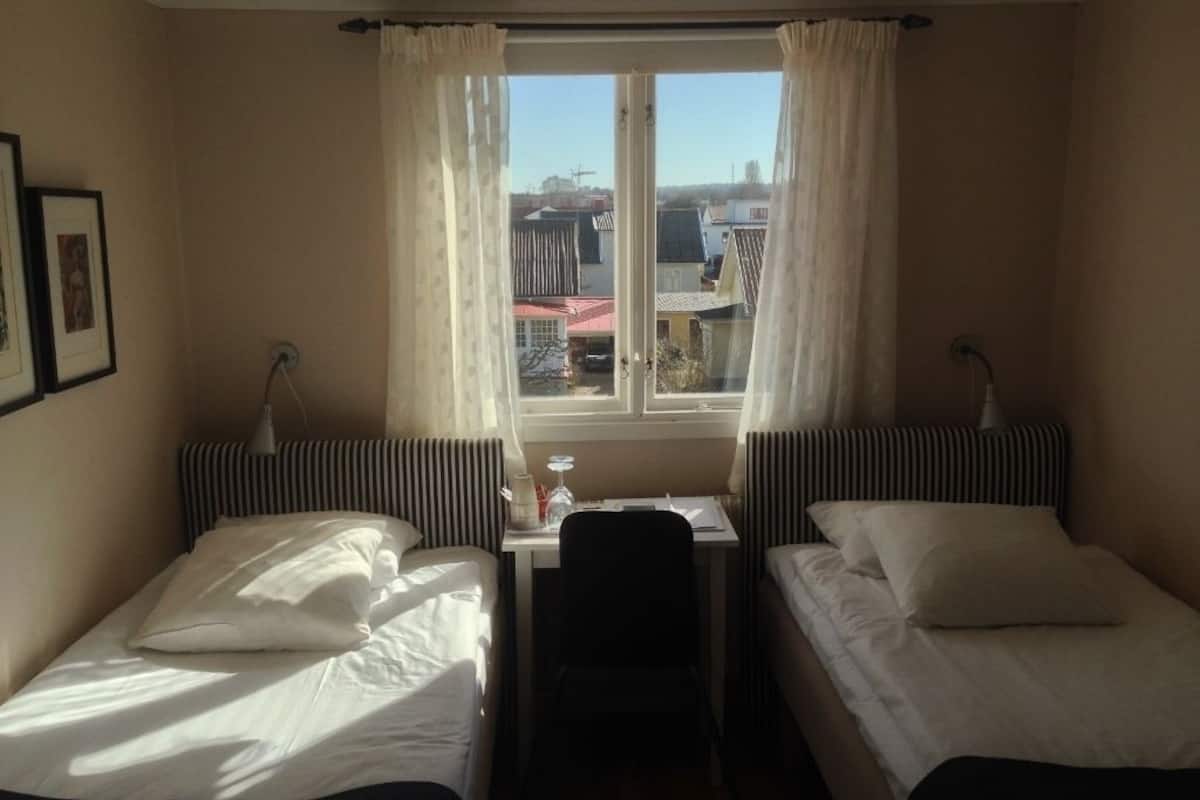 economy twin room, shared bathroom | premium bedding, blackout curtains, iron/ironing board, travel cot