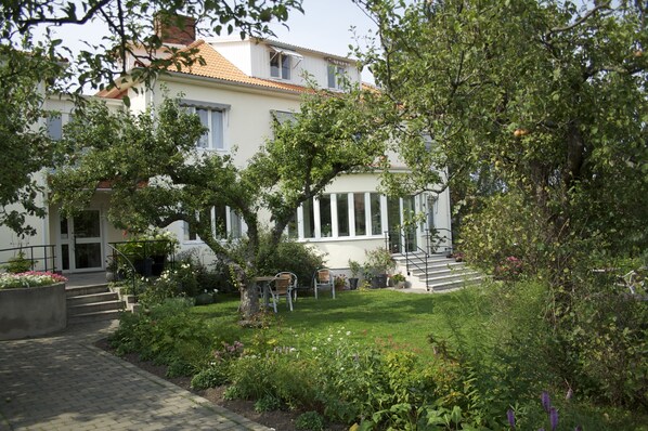 A house with a garden, a staircase, and a door.