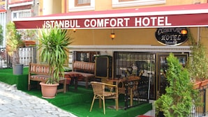 The exterior of Istanbul Comfort Hotel with outdoor seating and potted plants. - Istanbul Comfort Hotel (Istanbul)