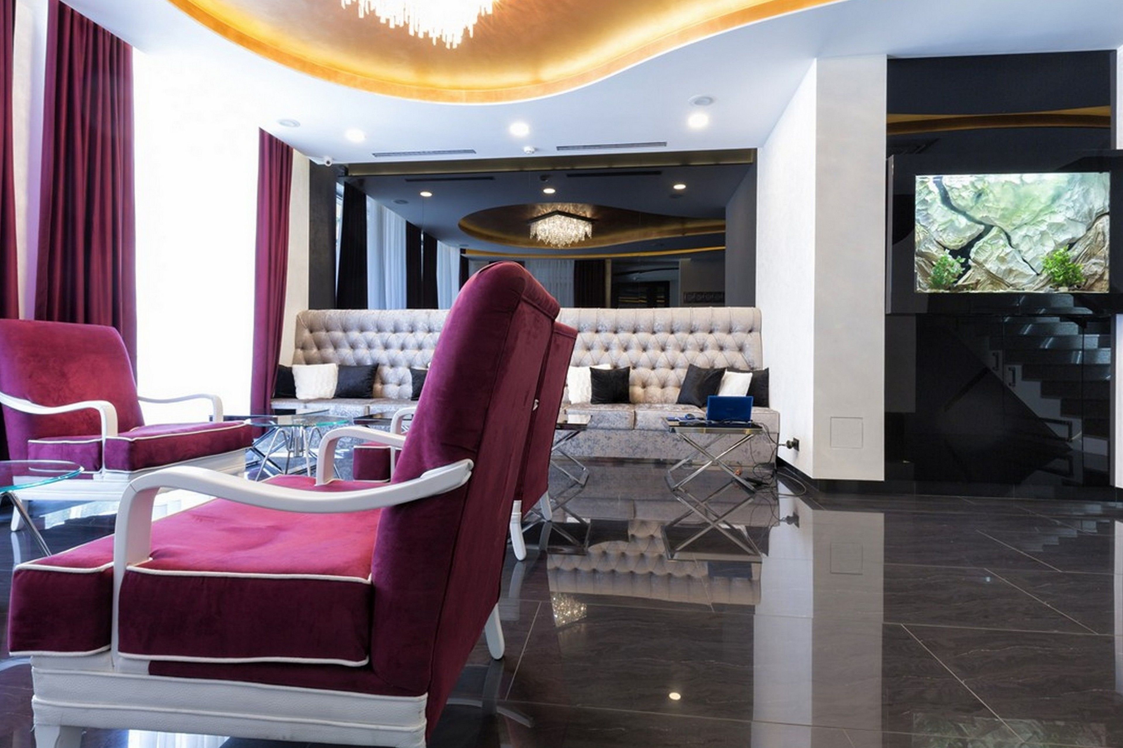 A modern living room with a sofa, chairs, and a television.