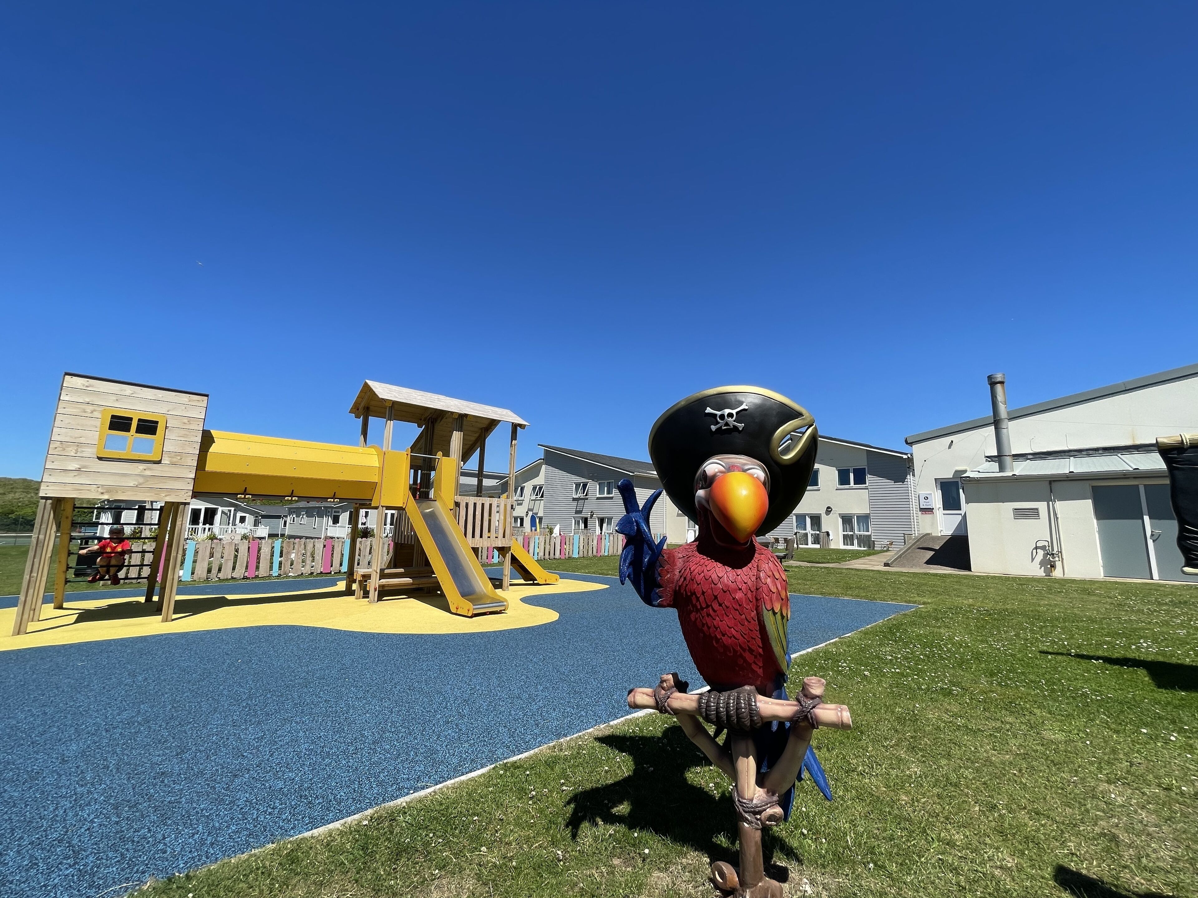A playground with a slide and climbing structures.