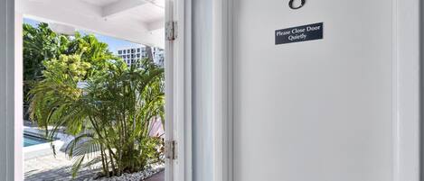 A door with a sign reading "Please Close Door Quietly" and the number 8.