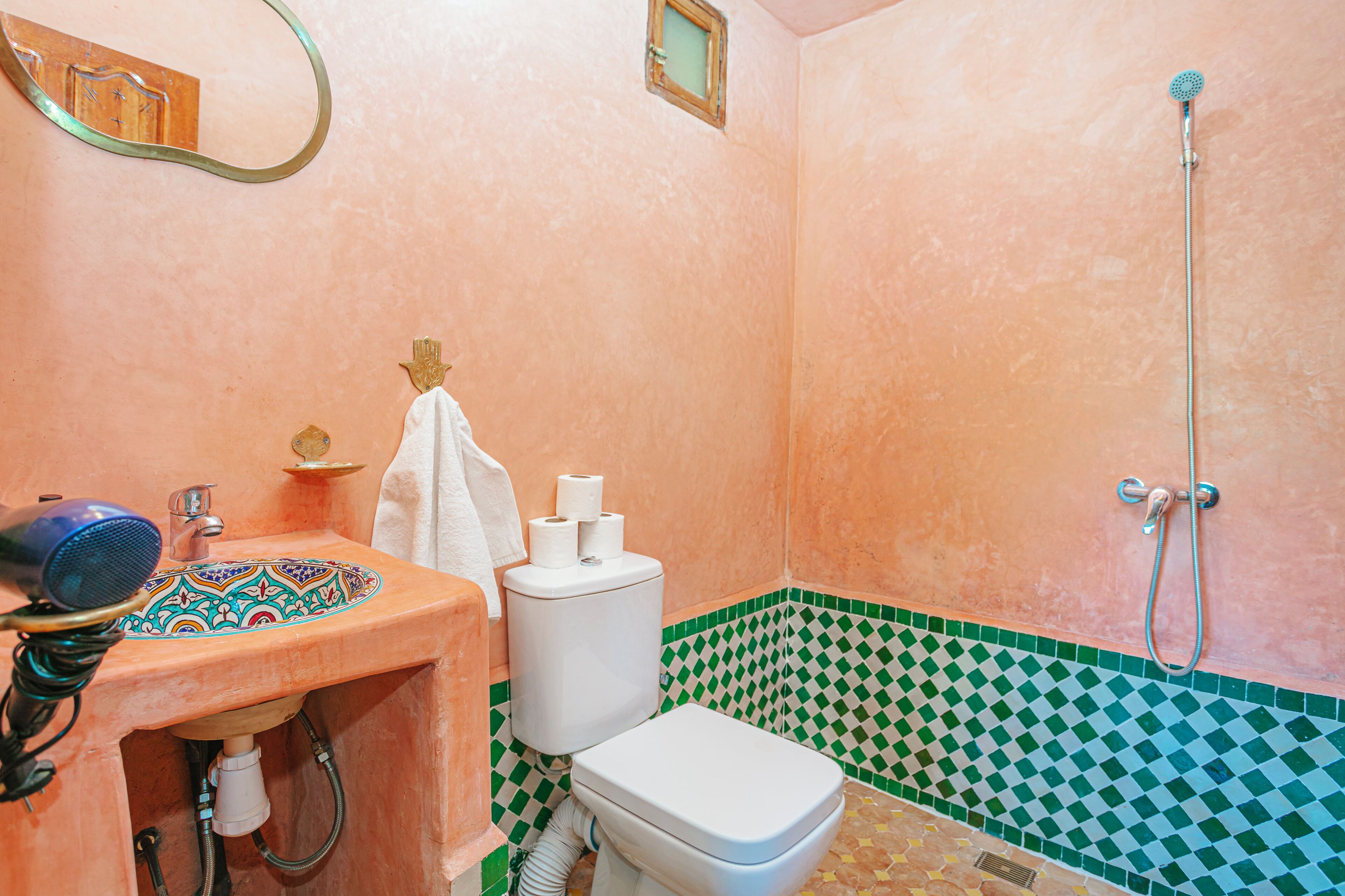 A bathroom with a sink, toilet, and shower.