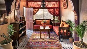 A cozy interior with a sofa, a coffee table, and a bookshelf. - Atlas Prestige (Asni)
