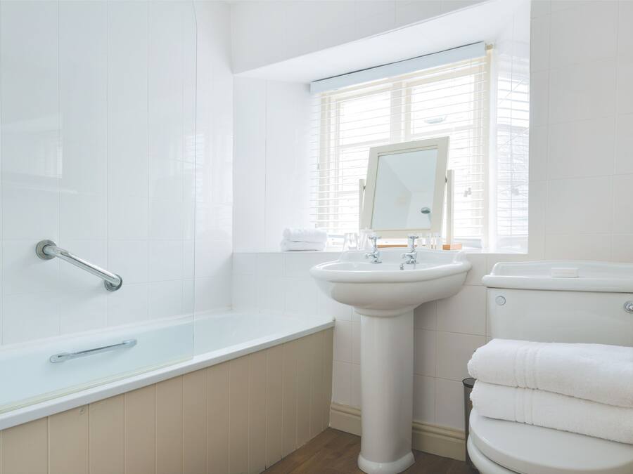 A bathroom with a bathtub, sink, and toilet.