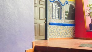 A set of outdoor stairs leading to a door with the number 101, surrounded by colorful walls and a tiled floor. - Hotel Baja del Sol Inn (Playas de Rosarito)