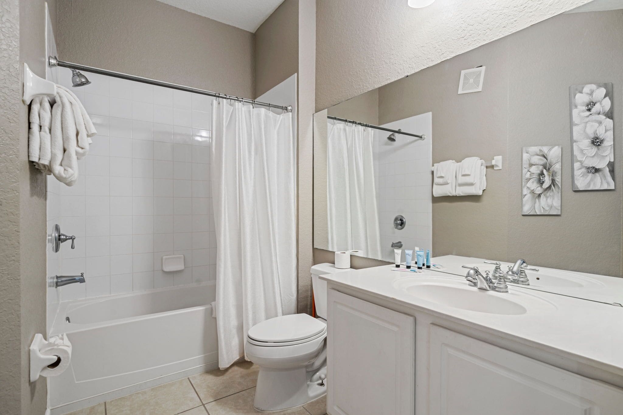 A modern bathroom with a bathtub, toilet, and sink.