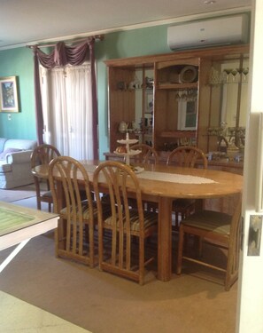 A dining room with a wooden table and chairs, a mirror, and a dining set. - Beulah Hotel Boutique (Asunción)
