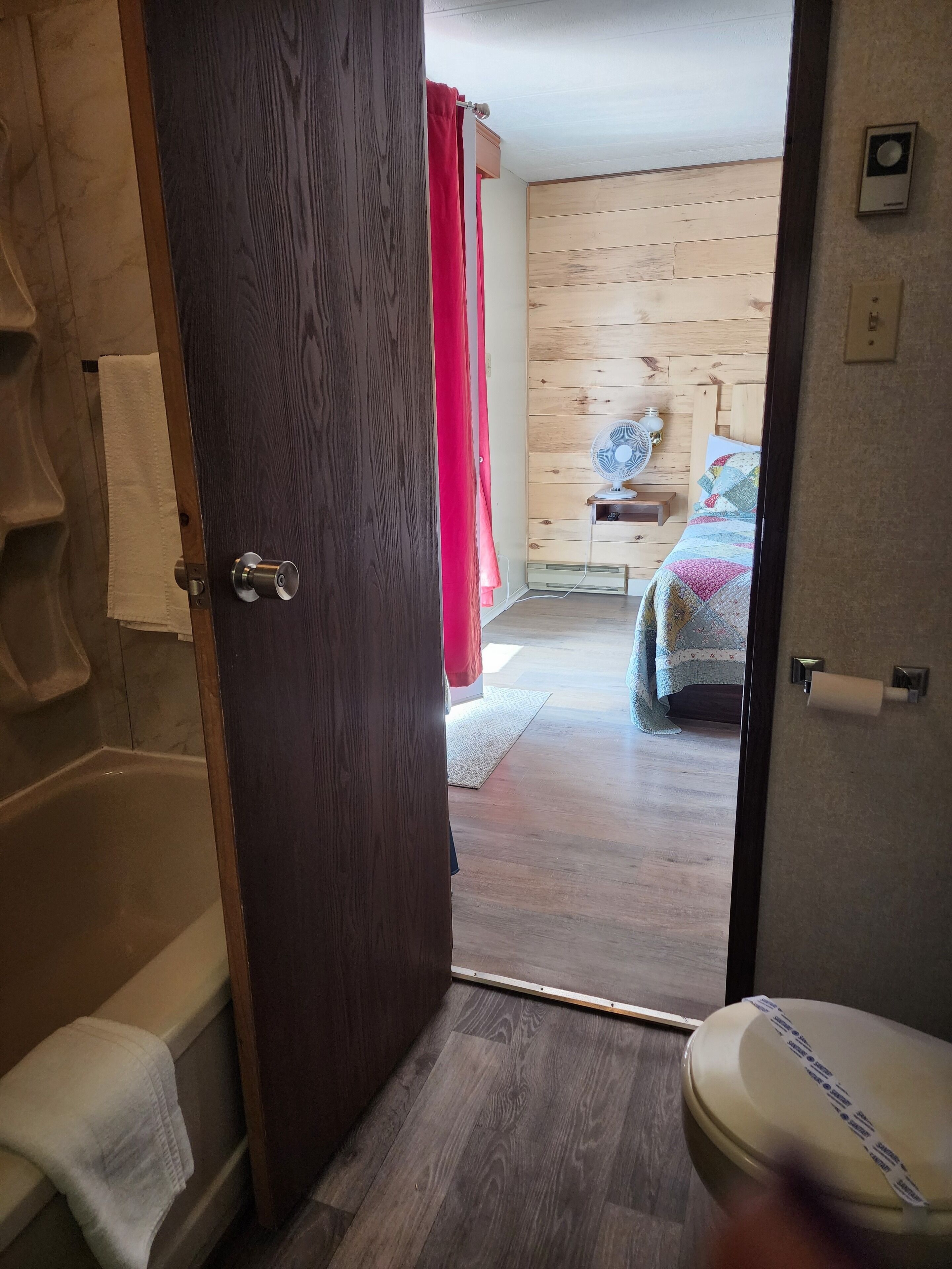A bathroom with a toilet, a sink, and a shower.