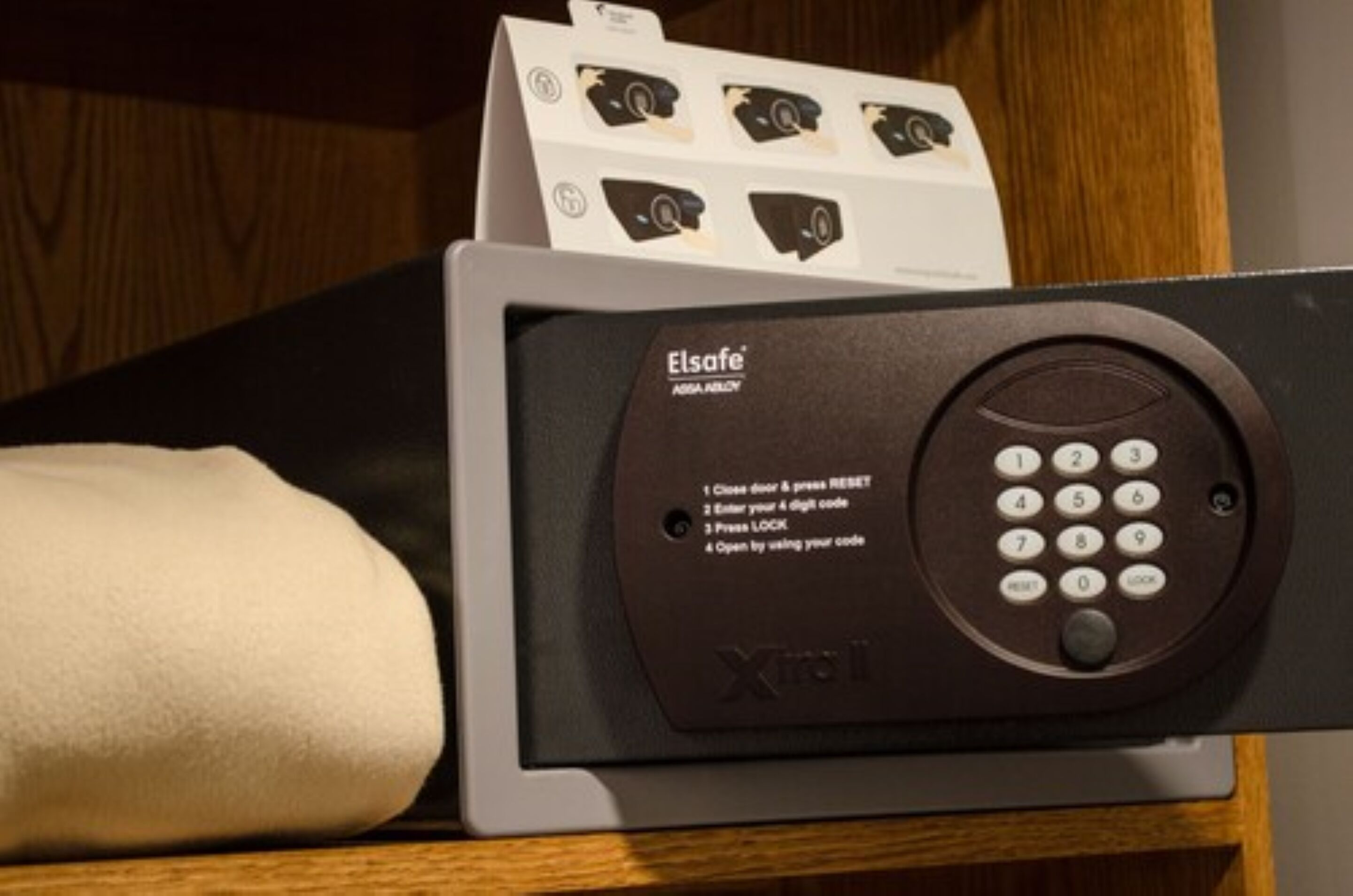 A security keypad with instructions for use, a card reader, and a card with a photo.