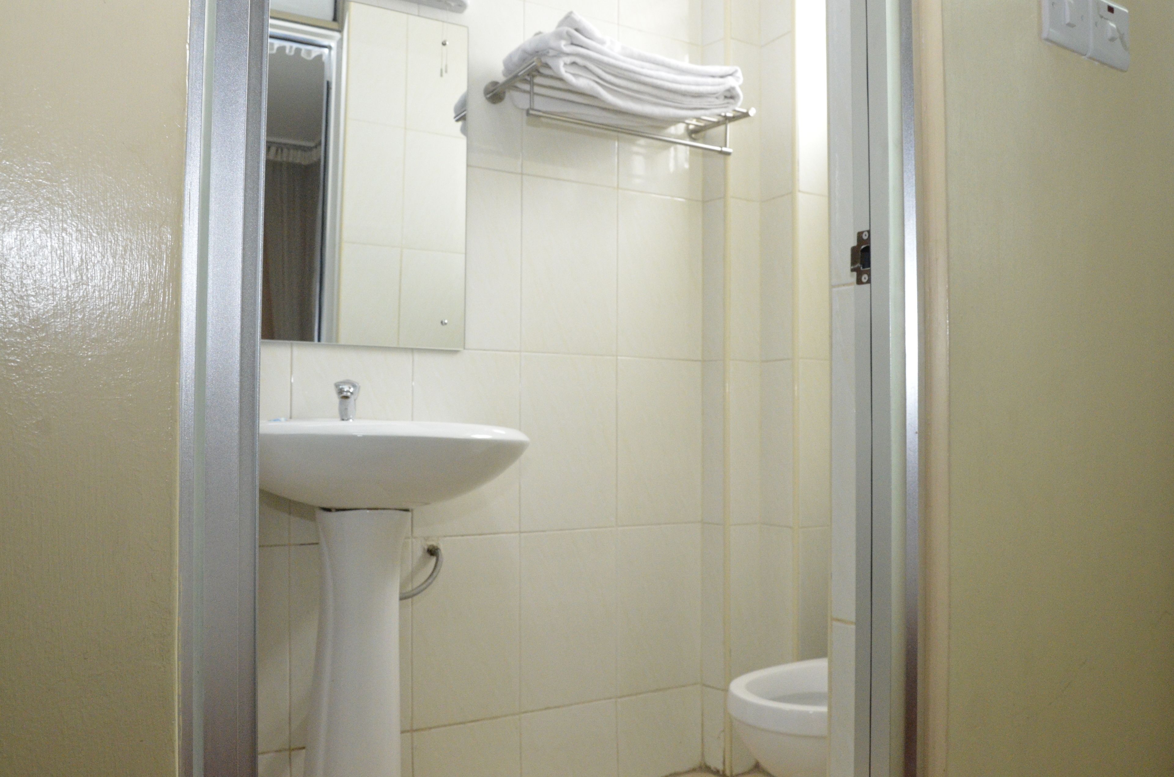 Ein Badezimmer mit Waschbecken, Toilette und Handtuchhalter.