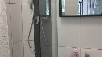 Shower, towels, soap, toilet paper