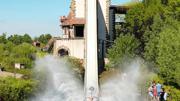 A water ride with a castle-like structure in the background.