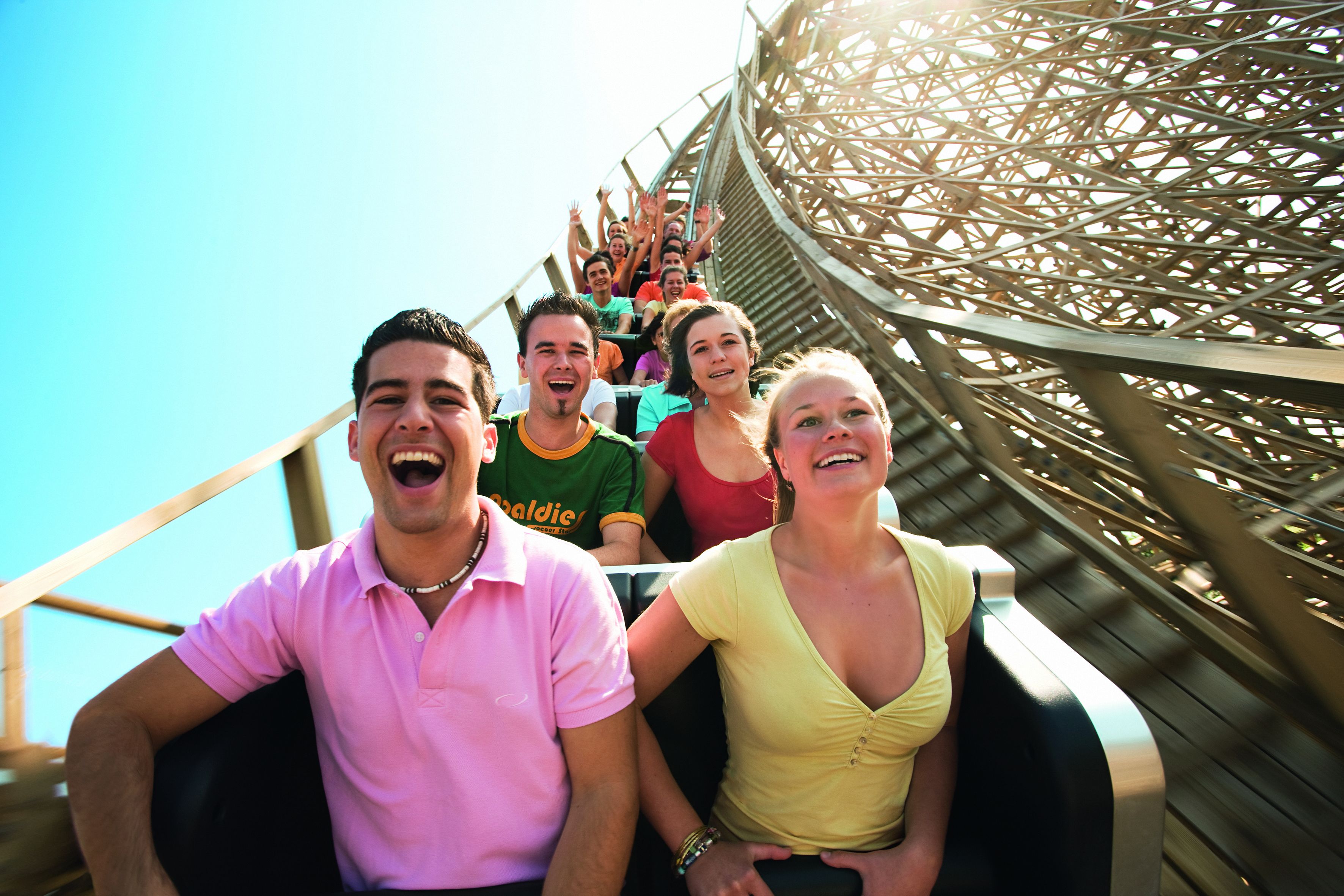 A roller coaster with passengers seated in the cars.