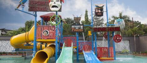 A pirate-themed water park with slides and a sign reading "Welcome to Pirate Island."