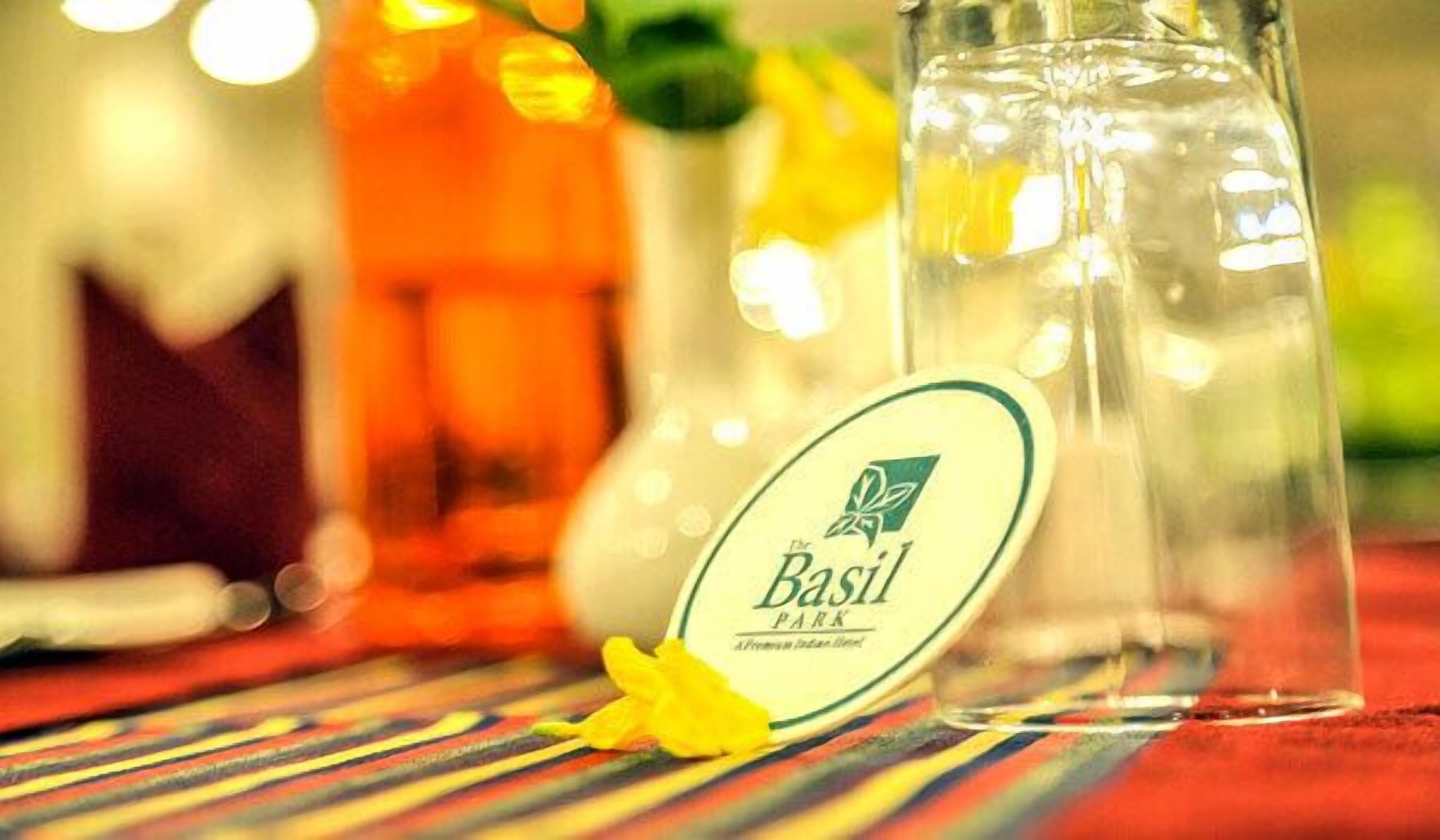 A bottle labeled 'Basil Park' with a yellow flower beside it.