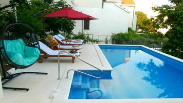 Seasonal outdoor pool, open 9:00 AM to 8:00 PM, pool umbrellas
