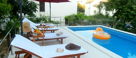 Seasonal outdoor pool, pool umbrellas, pool loungers