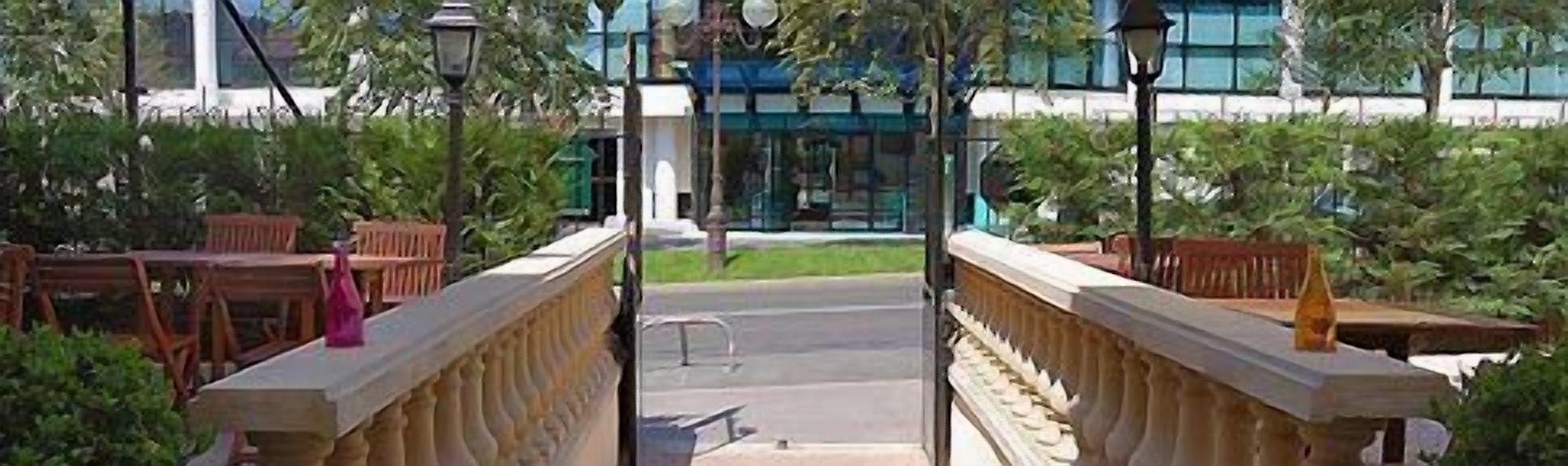 A bridge with a balustrade leading to a building entrance.