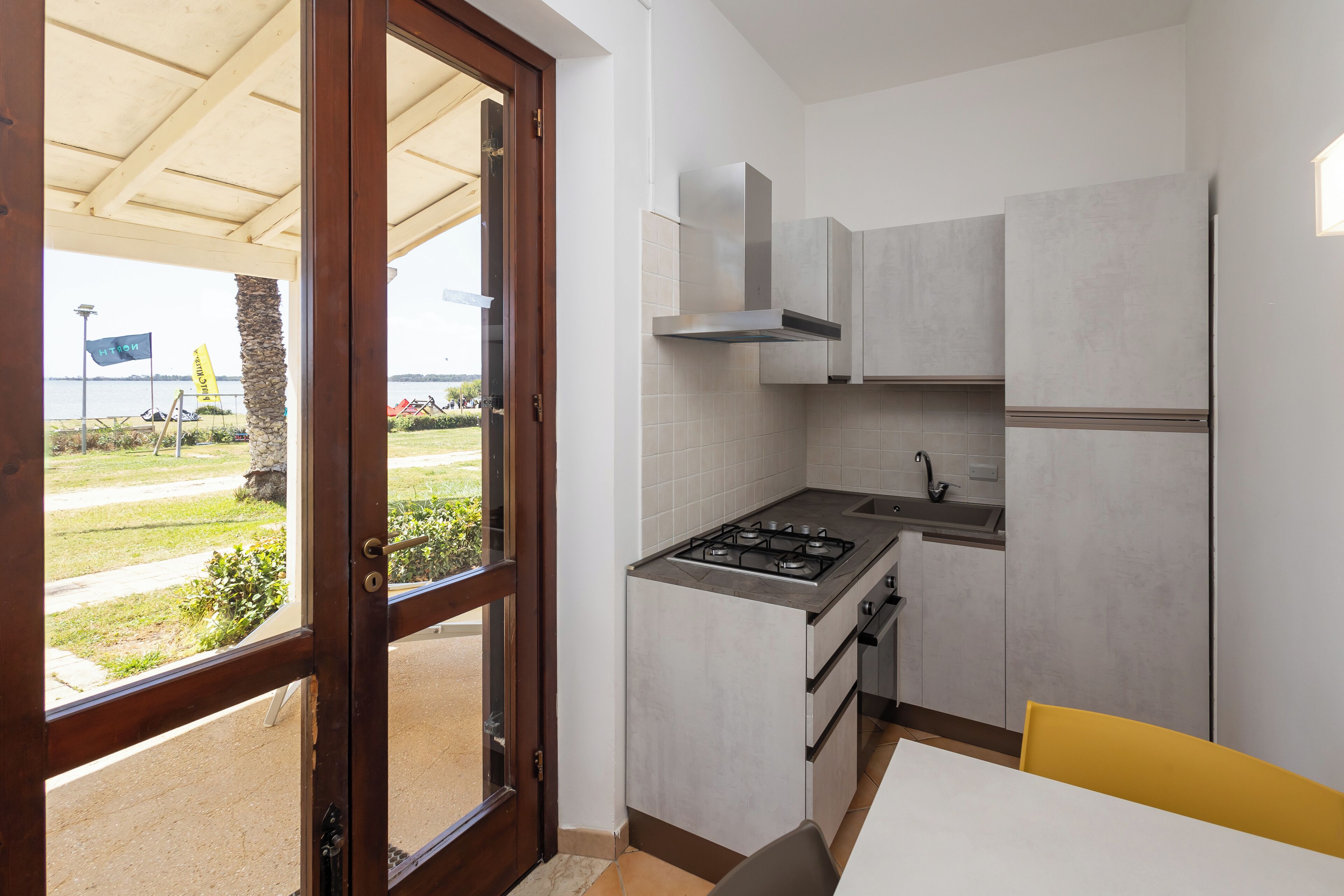 A compact kitchen with a gas stove, oven, and modern cabinetry.