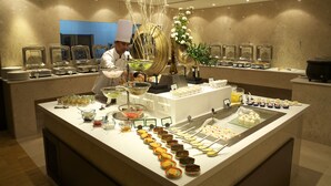 Ein reichhaltiges Buffet mit verschiedenen Speisen und einem Koch, der kocht.