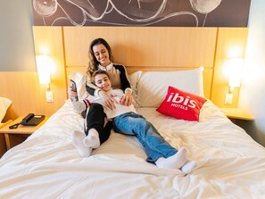 Rest in comfort with a plush bed and convenient bedside telephone.