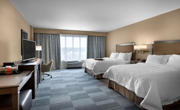A hotel room with two beds, a desk with a television, a chair, and a window with curtains. - Hampton Inn & Suites Fort Mill (Fort Mill)