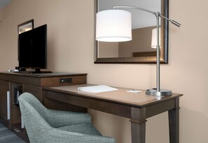 A hotel room with a desk, a chair, a television, and a lamp. - Hampton Inn & Suites Fort Mill (Fort Mill)