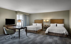 A hotel room with two beds, a desk with a TV, a chair, and a window with curtains. - Hampton Inn & Suites Fort Mill (Fort Mill)