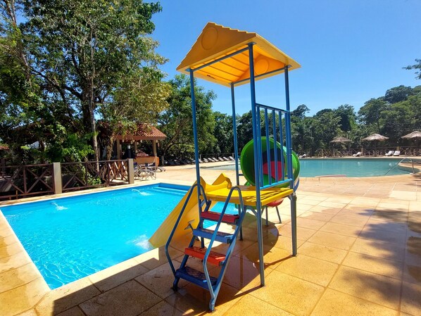 A swimming pool with a slide and a play structure. - Village Cataratas (Puerto Iguazú)