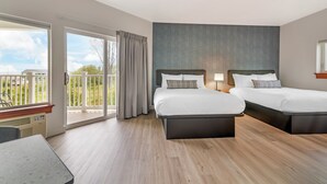 A hotel room with two beds, a balcony with a view, and a large window. -  Ocean Sands at York Beach (York Beach)