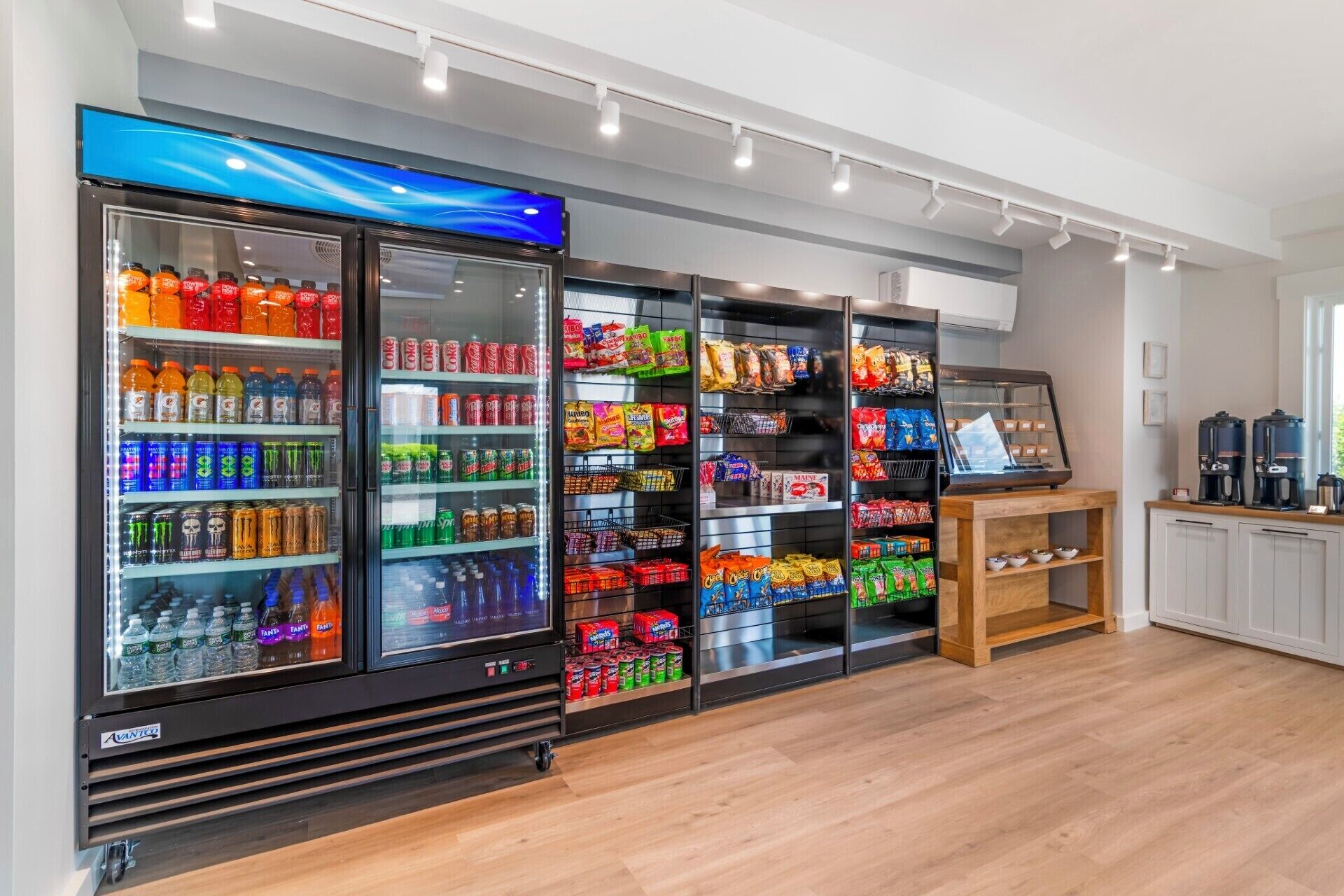 A beverage vending area with multiple drink dispensers and snack shelves.