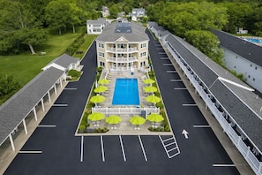 A hotel with a central swimming pool, multiple balconies, and a parking lot. - Ocean Sands at York Beach (York Beach)