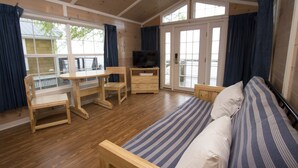 A room with a bed, a desk, a chair, and a television. - Cedar Point's Lighthouse Point (Sandusky)