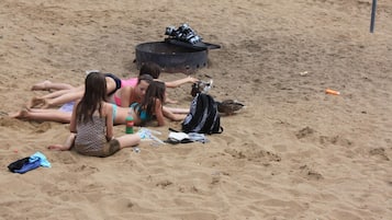 Guests can enjoy a casual beach gathering with access to a grill and amenities for a relaxing day by the ocean.