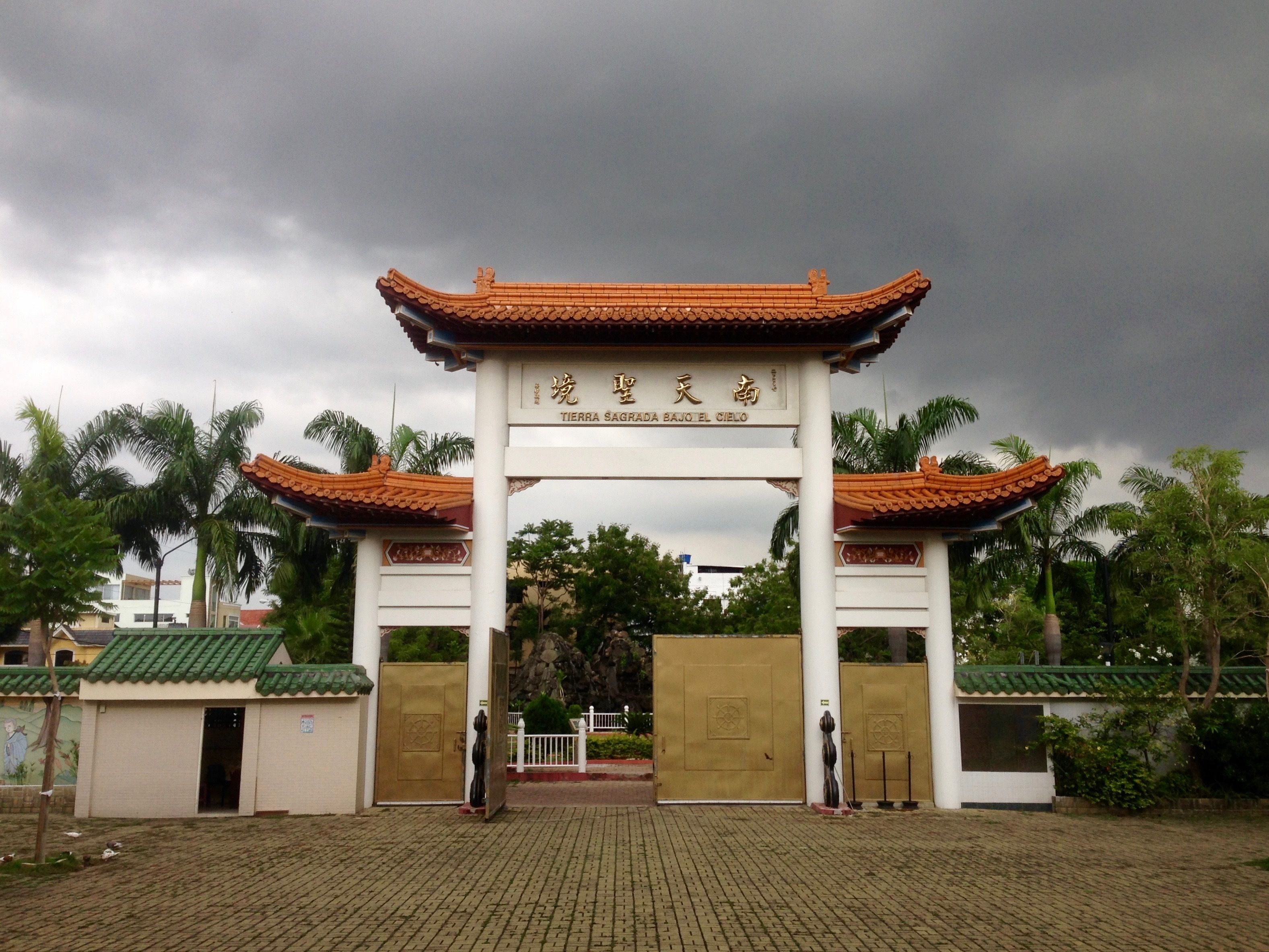 Una puerta tradicional china con un cartel que dice "Tierra Sagrada Bajo el Cielo".
